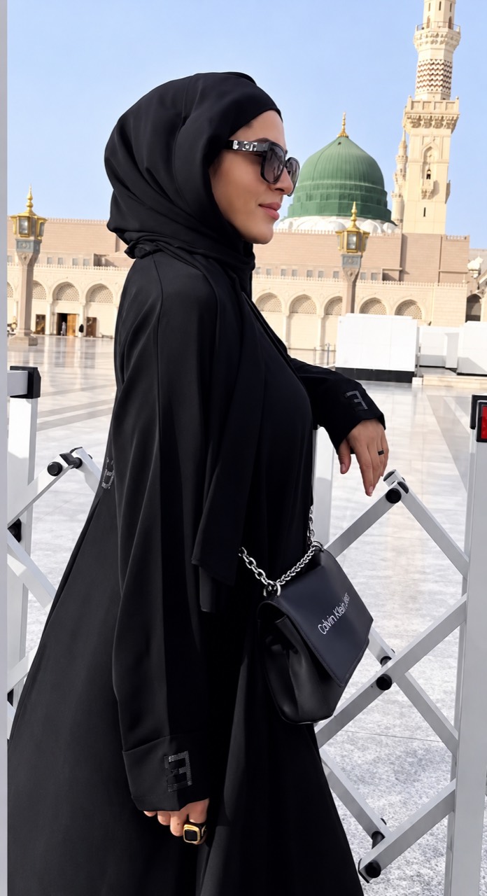 Nergis Abilova standing outdoors, dressed in black